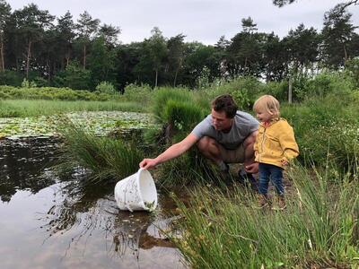 Me and my daughter Mirthe setting free some tadpoles (photo taken by my wife, Saskia)